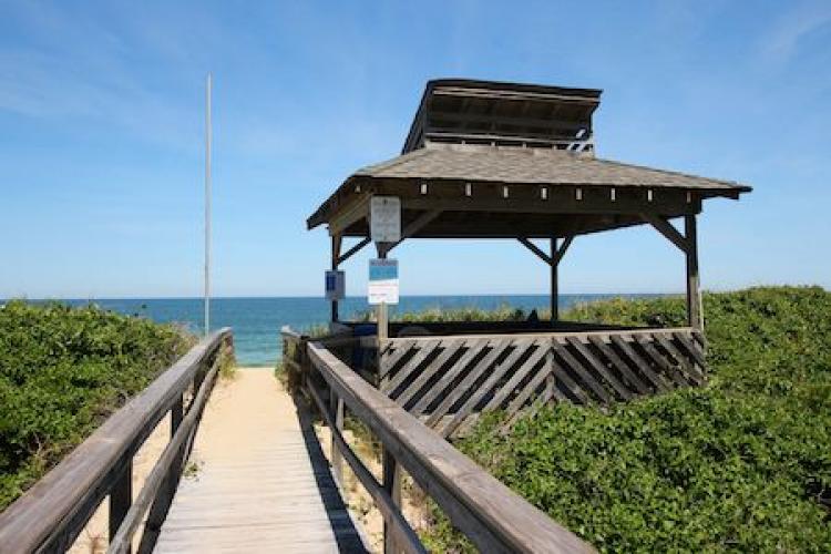 boardwalk to the ocean at colony by the sea in duck nc
