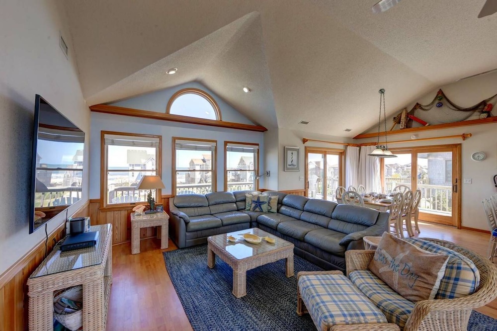 view of couch and large windows in living room of hatteras island holiday vacation rental