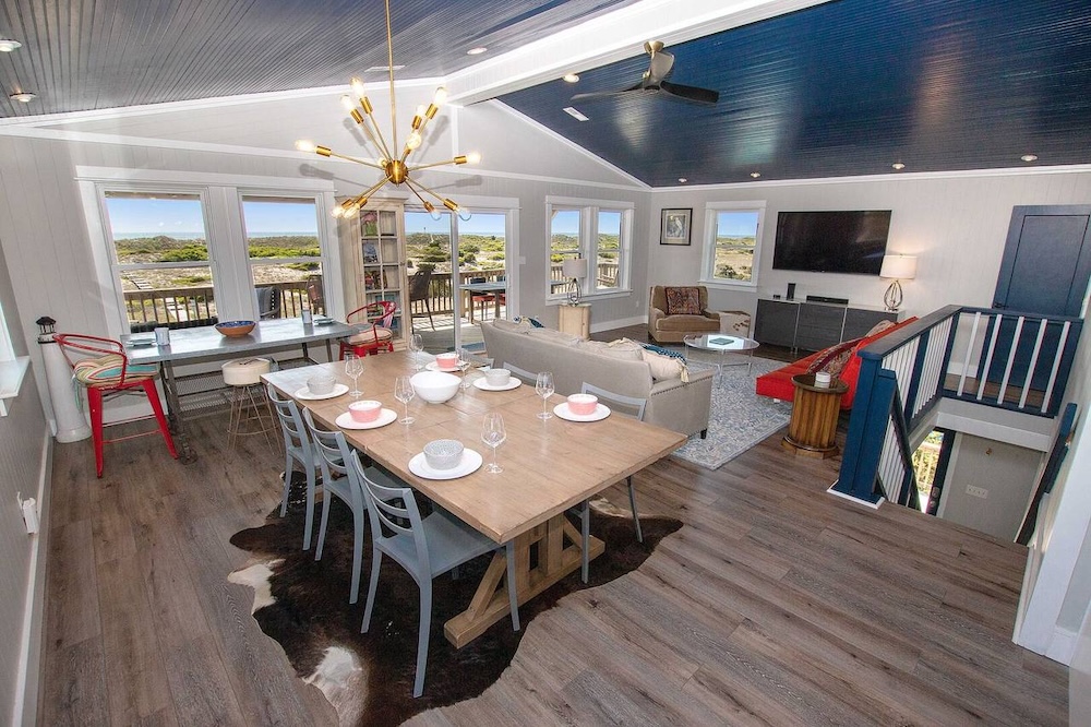 view of dining table and living room in a holiday rental on hatteras island